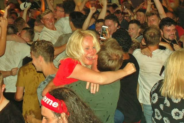 Regulars at The Cutting Room in Melton celebrate at the final whistle after watching on a big screen at the pub as England beat Sweden to reach the World Cup semi-finals EMN-180907-103729001