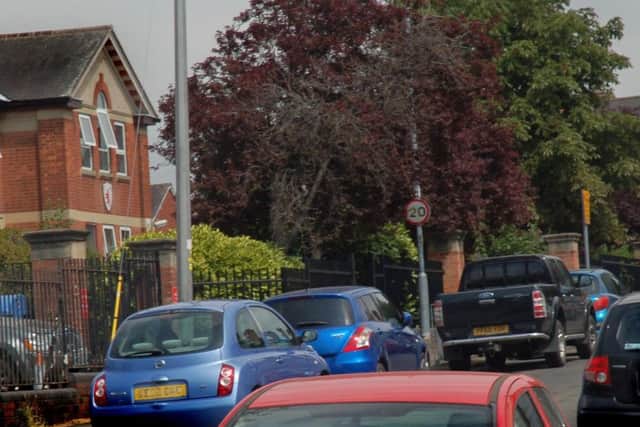 Parked cars outside Brownlow Primary School, Melton, on Monday afternoon - there has been an issue with parents blocking the road and 'no parking' places for many years EMN-180907-163437001