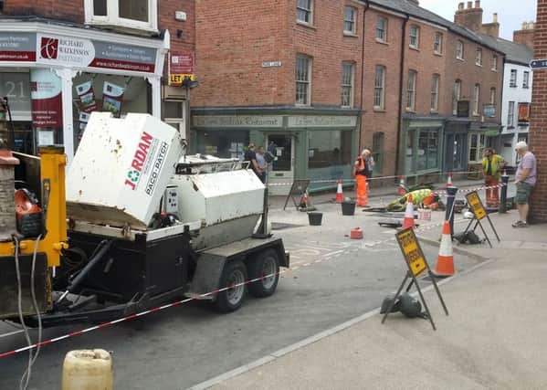 County council contractors begin to repair rattling manhole covers in Leicester Street, Melton, with the road set to be closed for up to four days EMN-180717-150020001