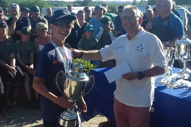 Chris is presented with his trophy as national champion EMN-180718-084523002