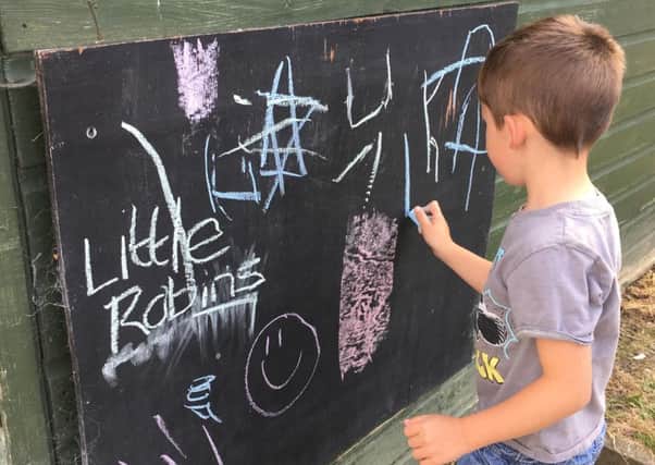 A child getting creative on the chalk board PHOTO: Supplied