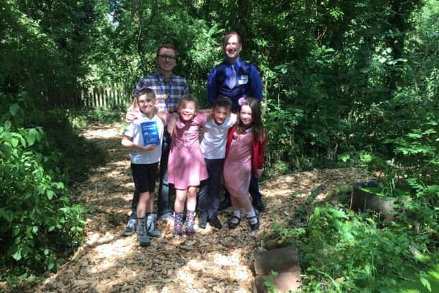 David Amps, teacher at Asfordby Hill Primary School (left), and Jack Gallacher, The Melton Building Society branch manager, with children from Asfordby Hill Primary School PHOTO: Supplied