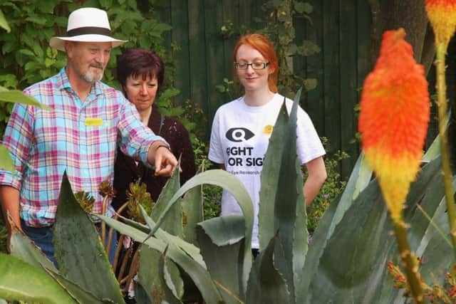 Richard Lawrence shows Shirley Freer and Rebecca Ingle around border of Agave and Red Hot Poker PHOTO: Tim Williams