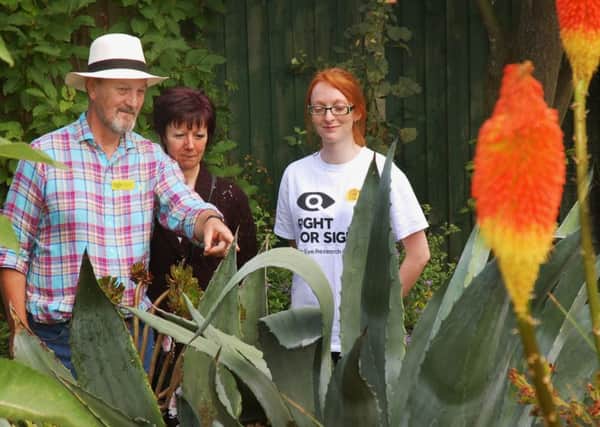 Richard Lawrence shows Shirley Freer and Rebecca Ingle around border of Agave and Red Hot Poker PHOTO: Tim Williams