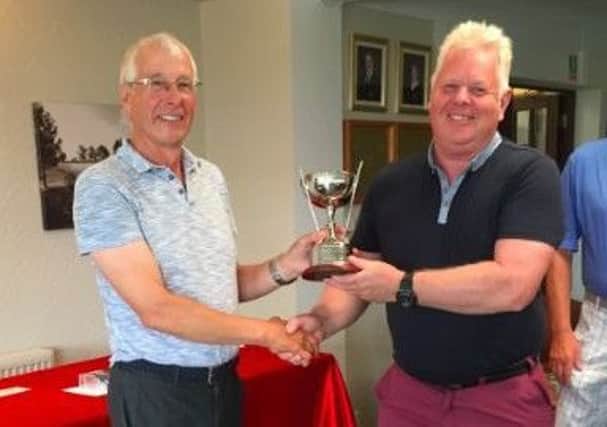 Seniors captain Jerzy Schmidt (left) presents the Goodacre Bowl to John Rigby EMN-180719-163224002