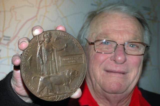 War historian Trevor Hearn, with a medal from the First World War, who died at the age of 73. Picture: Tim Williams EMN-180724-122813001