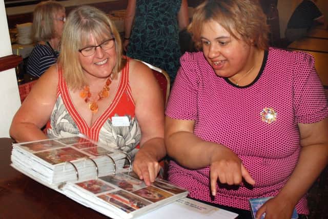 Former nursery nurse Karen Williamson and ex-pupil Joleen Peet look at old school albums at a reunion for The Mount School in Melton EMN-180724-131559001
