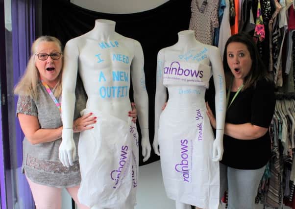 Not a thing to wear... Rainbows shop manager Lucinda Hardy (right), with deputy shop manager Karen McGinnigle, and mannequins Fred and Ginger' PHOTO: Supplied