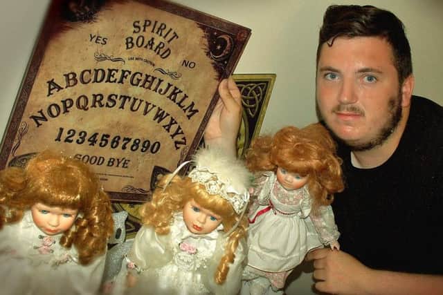 Ben Canham, who suffers from Asperger's Syndrome, with dolls and other items which he says he uses to contact spirits from beyond the grave EMN-180725-164223001