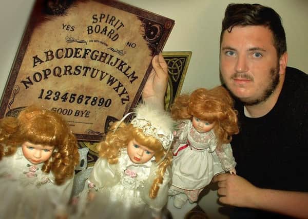 Ben Canham, who suffers from Asperger's Syndrome, with dolls and other items which he says he uses to contact spirits from beyond the grave EMN-180725-164223001
