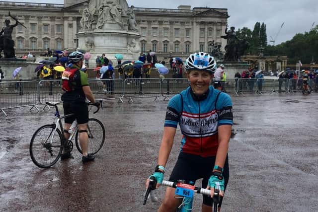 Theresa Coltman pauses for a photo with Buckingham Palace at a sodden Ride London EMN-180708-175438002
