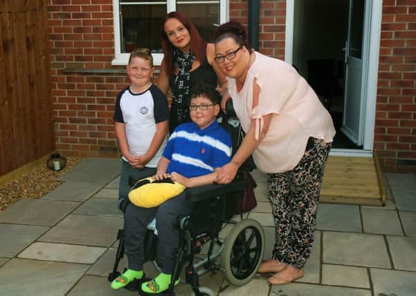 William Billingsley pictured a year ago with mum Karen Dack (right), brother Finlay and family friend Natalie Brown, who organised a community DIY SOS campaign to redesign the back garden EMN-180808-092750001