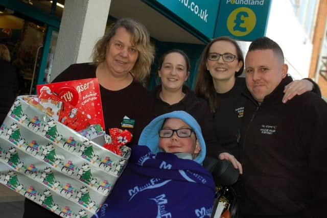 Melton boy William Billingsley is presented with his special advent calendar by staff at the town's Poundland store EMN-180808-092615001