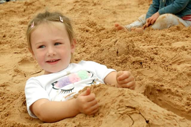Three-year-old Ivy Whitcombe relaxes in the sandpit PHOTO: Tim Williams
