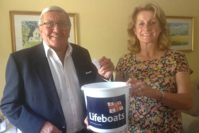Bill Roberts of Hoby (chairman) conducting the RNLI's summer prize draw with Karen Brett of Holwell (secretary) PHOTO: Supplied
