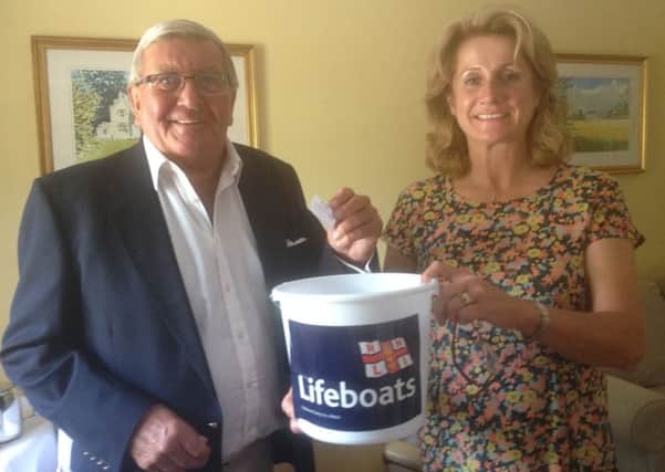 Bill Roberts of Hoby (chairman) conducting the RNLI's summer prize draw with Karen Brett of Holwell (secretary) PHOTO: Supplied