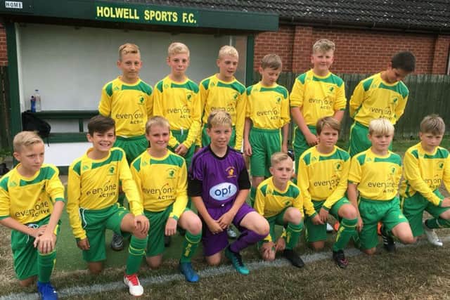 Holwell Junior Football Academy pose in their kits sponsored by Everyone Active EMN-180815-124450002