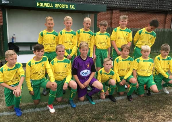 Holwell Junior Football Academy pose in their kits sponsored by Everyone Active EMN-180815-124450002