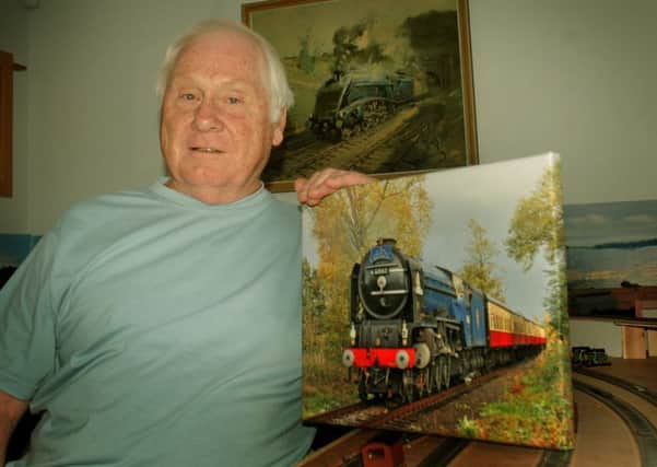Steam train enthusiast Paul Davies with some of the railway memorabilia he has collected EMN-180813-095003001