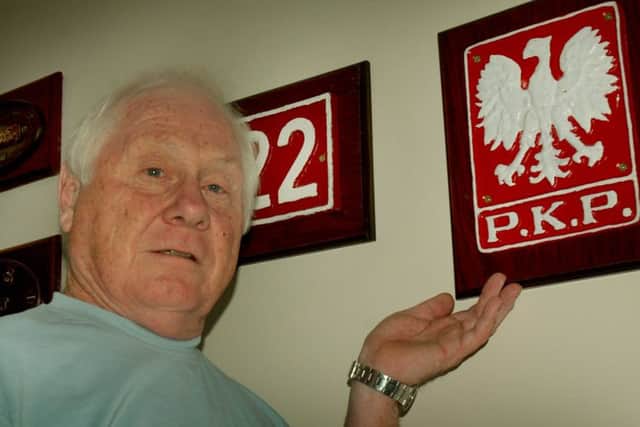 Steam train enthusiast Paul Davies with a Polish railway locomotive signage souvenir EMN-180813-095014001
