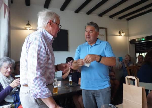 Keith Wadkin presenting the cheque for £526 to Nottingham University Medical School professor Kevin Morgan PHOTO: Supplied