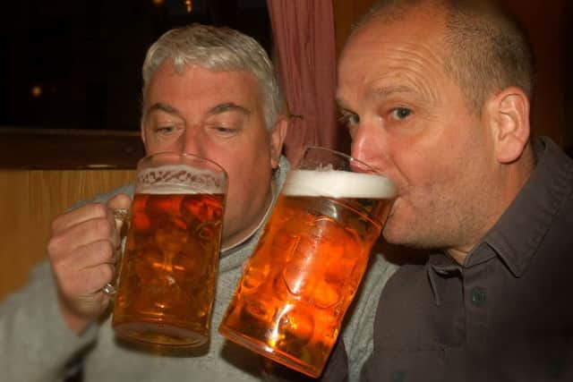 Richard Wardhaugh and Dave Core get stuck into their steins of Lowenbrau PHOTO: Tim Williams