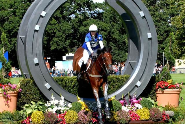 The Land Rover Burghley Horse Trials - Sarah Cohen on Treason jumps through the Olympic Horseshoe at the start of the cross-country ENGANL00120140502124035