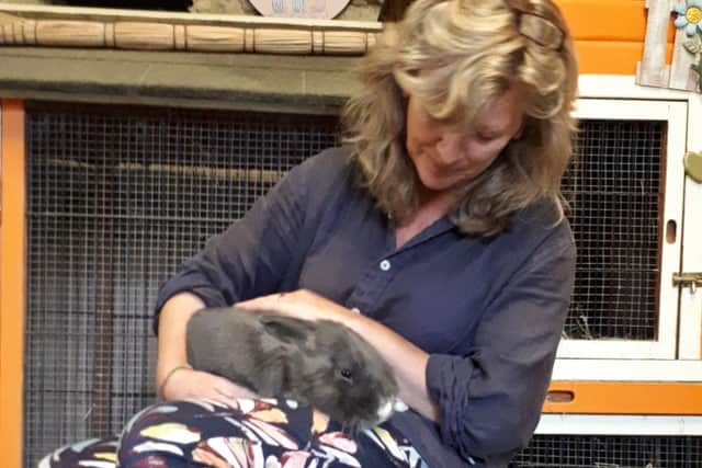 Lisa Newton looks after a rabbit at her Hop Inn hotel EMN-180828-160237001