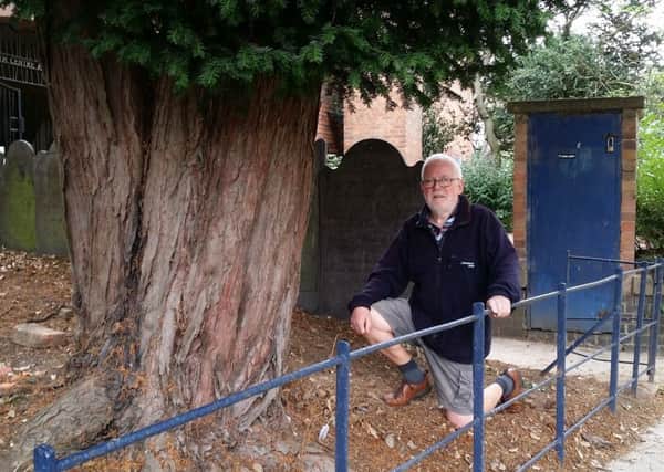 John Craig next to the yew tree, which has a protection order on it, and in front of the old boiler house, which both have to be removed to make way for a new building at St Mary's Church in Melton EMN-180409-150929001