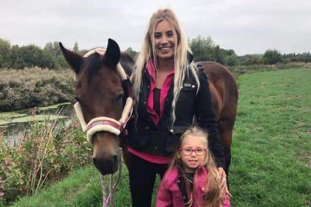 Kayleigh Walling, with three-year-old daughter Brooke, and her horse Milly, which was rescued by firefighters from the River Wreake at Frisby EMN-180409-164155001