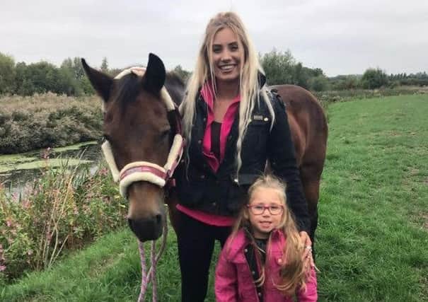 Kayleigh Walling, with three-year-old daughter Brooke, and her horse Milly, which was rescued by firefighters from the River Wreake at Frisby EMN-180409-164155001