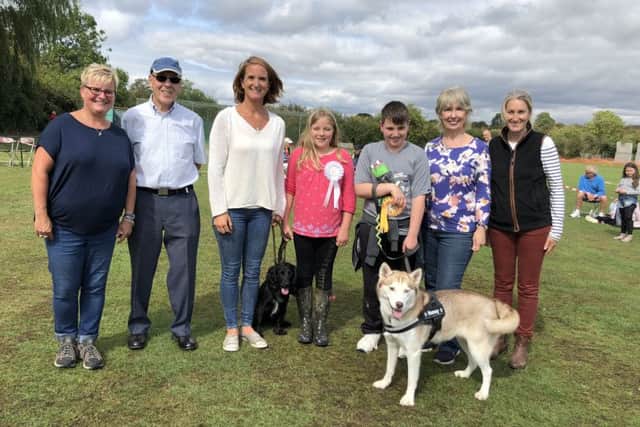 (From left to right): Sharon Barber, Barry Lewell, Sarah Moulds and daughter with reserve best in show working spaniel Brior, master Clarke with winner of best in show husky Honey, Lynne Marshall and Kate Warren Price PHOTO: Supplied