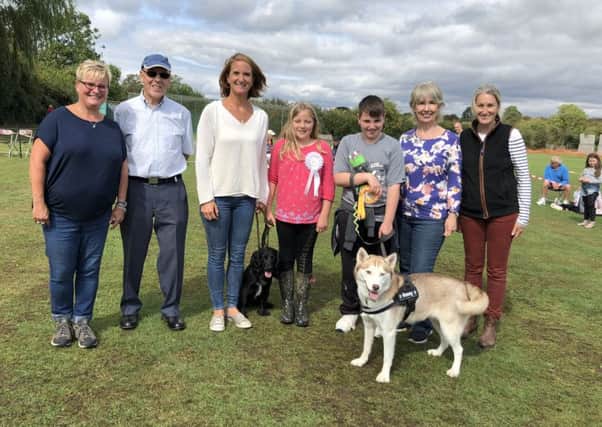 (From left to right): Sharon Barber, Barry Lewell, Sarah Moulds and daughter with reserve best in show working spaniel Brior, master Clarke with winner of best in show husky Honey, Lynne Marshall and Kate Warren Price PHOTO: Supplied