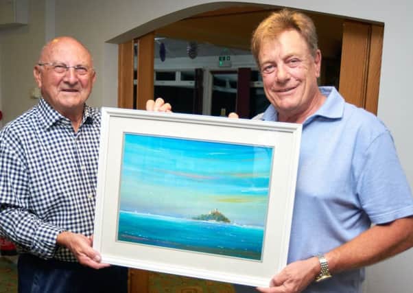 Melton Golf Club captain and auctioneer Glenn Price (right) with the painting donated by artist Brian Hodder (left) PHOTO: Derek Whitehouse
