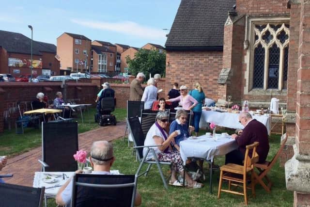 Cream teas are served in the gardens of St John's Catholic Church in Melton - the proceeds willl go to sprucing up the gardens EMN-180509-160739001