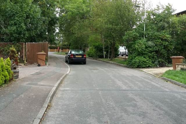 Gartree Court in Melton - a car with three people in travelled from the driveway on the right, across the road to the driveway on the left and ended up on its side after hitting the fence and gates EMN-181009-133843001