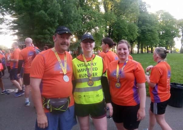 Richard Angrave helping visually impaired runner Leigh Pick at the Leicester Sunrise City 5K PHOTO: Supplied