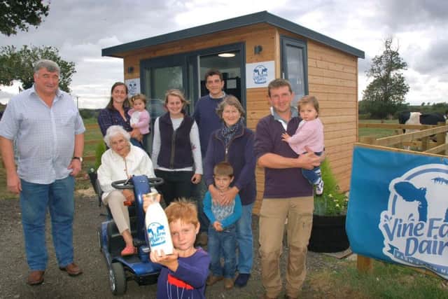 Farmers and villagers at the milk vending machine at Vine Farm, Great Dalby EMN-180919-095636001
