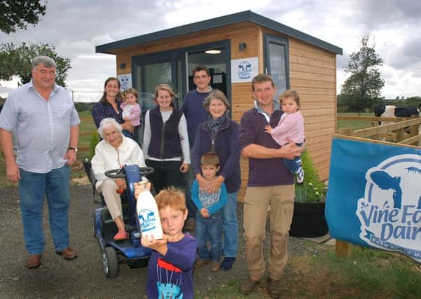 Farmers and villagers at the milk vending machine at Vine Farm, Great Dalby EMN-180919-095636001