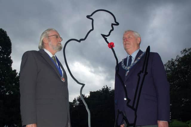 Senior townwarden, John Southerington (right) and Melton Town Estate trustee, Ian Wilkinson, with the striking new 'Tommy' silhouette installed at the memorial gardends to mark the 100th anniversary of the First World War EMN-180913-161323001
