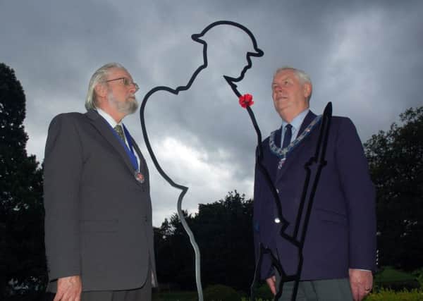 Senior townwarden, John Southerington (right) and Melton Town Estate trustee, Ian Wilkinson, with the striking new 'Tommy' silhouette installed at the memorial gardends to mark the 100th anniversary of the First World War EMN-180913-161323001