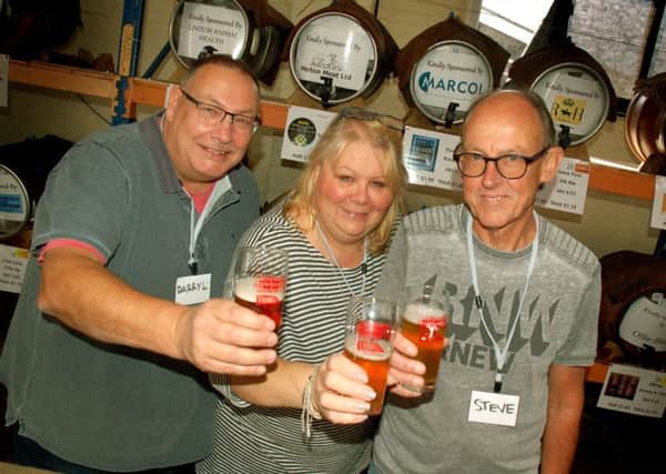 Darryl Bracey keeps the beers flowing with Jackie and Steve Ratcliffe PHOTO: Tim Williams
