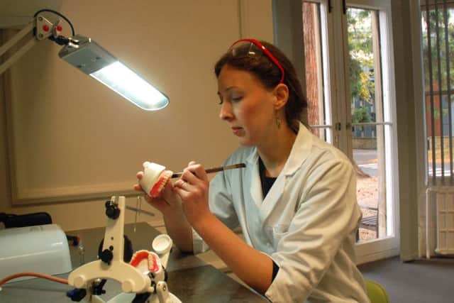 Melanie Griggs at work at her dental laboratory.