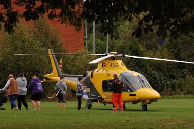 An air ambulance on the Play Close in Melton after reports of a man jumping from the railway bridge on Burton Street EMN-180924-112035001