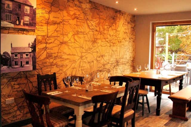 The restaurant area at the Tap and Run at Upper Broughton, with prints on the wall showing the pub as it looked as the Golden Fleece in byegone years EMN-180924-145000001