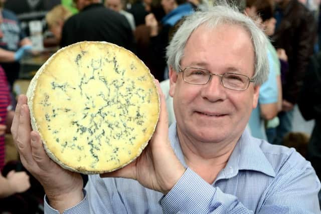 Matthew O'Callaghan, chair of the UK Protected Food Names Association and the Melton Mowbray Food Partnership, holding a drum of Stilton cheese EMN-180926-101005001