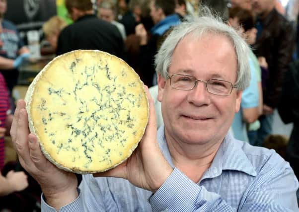 Matthew O'Callaghan, chair of the UK Protected Food Names Association and the Melton Mowbray Food Partnership, holding a drum of Stilton cheese EMN-180926-101005001