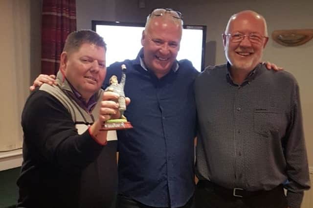 Winning team members Russell Freeman (left) and Alan Parkes (right) receive the Jocelyn Westwood Memorial Trophy from Melton GC professional Tony Westwood EMN-180925-185051002