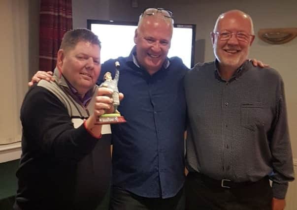 Winning team members Russell Freeman (left) and Alan Parkes (right) receive the Jocelyn Westwood Memorial Trophy from Melton GC professional Tony Westwood EMN-180925-185051002