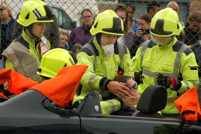 Firefighters carry out a demonstration on releasing a casualty from a traffic collision at a road safety awareness day at Melton Fire Station EMN-180110-105146001